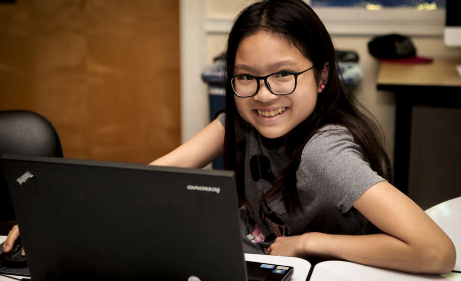 A smiling girl at a coding class